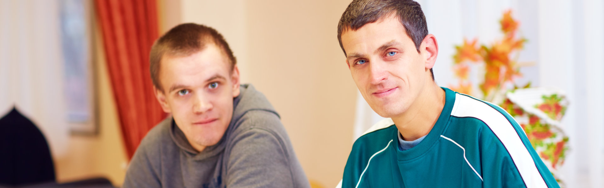 cheerful adult men sitting at the desk