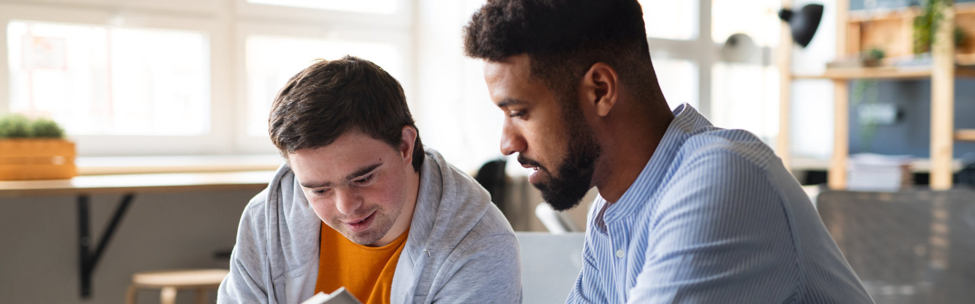 Young happy man with his tutor studying