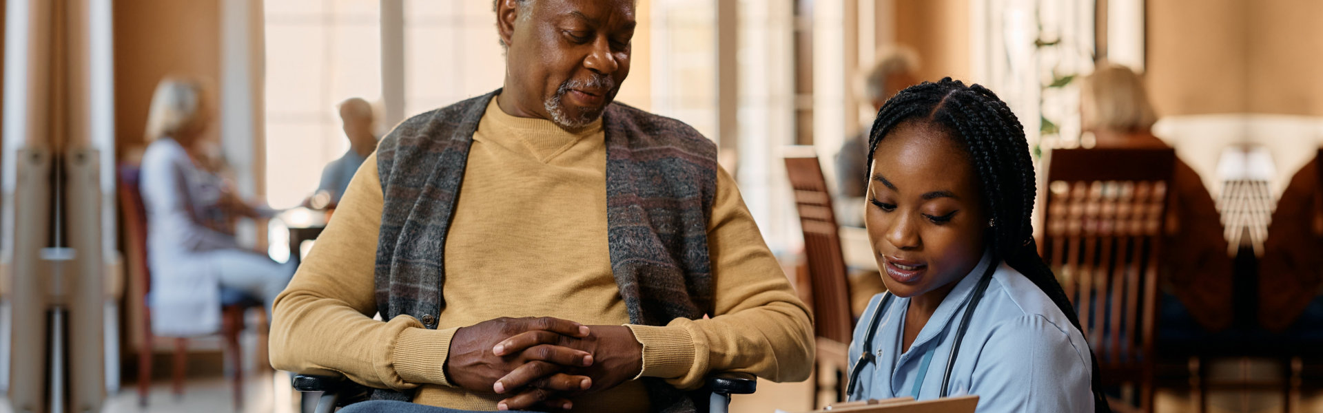 senior man and female caregiver talking